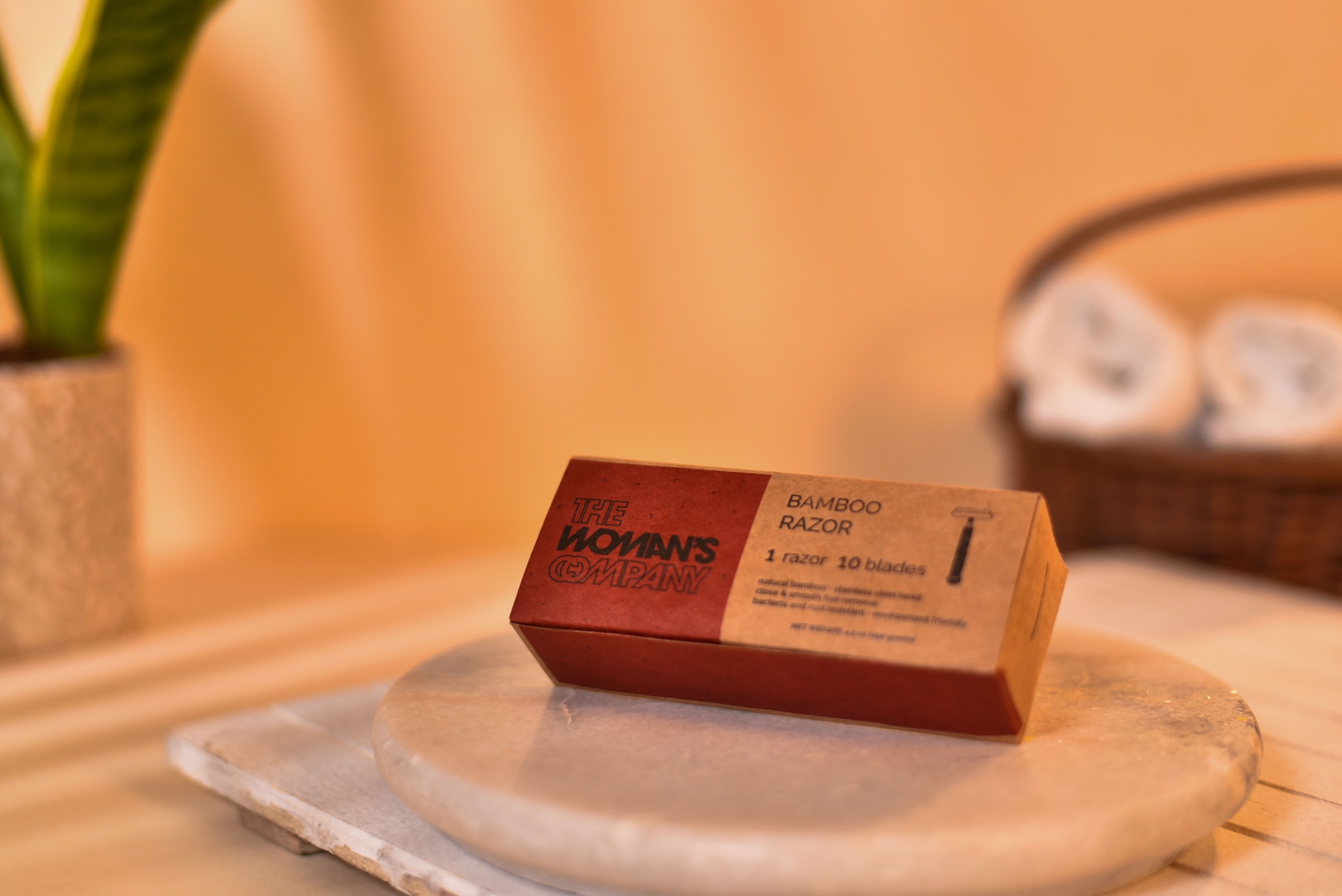 Bamboo razor packaged in a cardboard box from The Woman's Company with ten blades included.