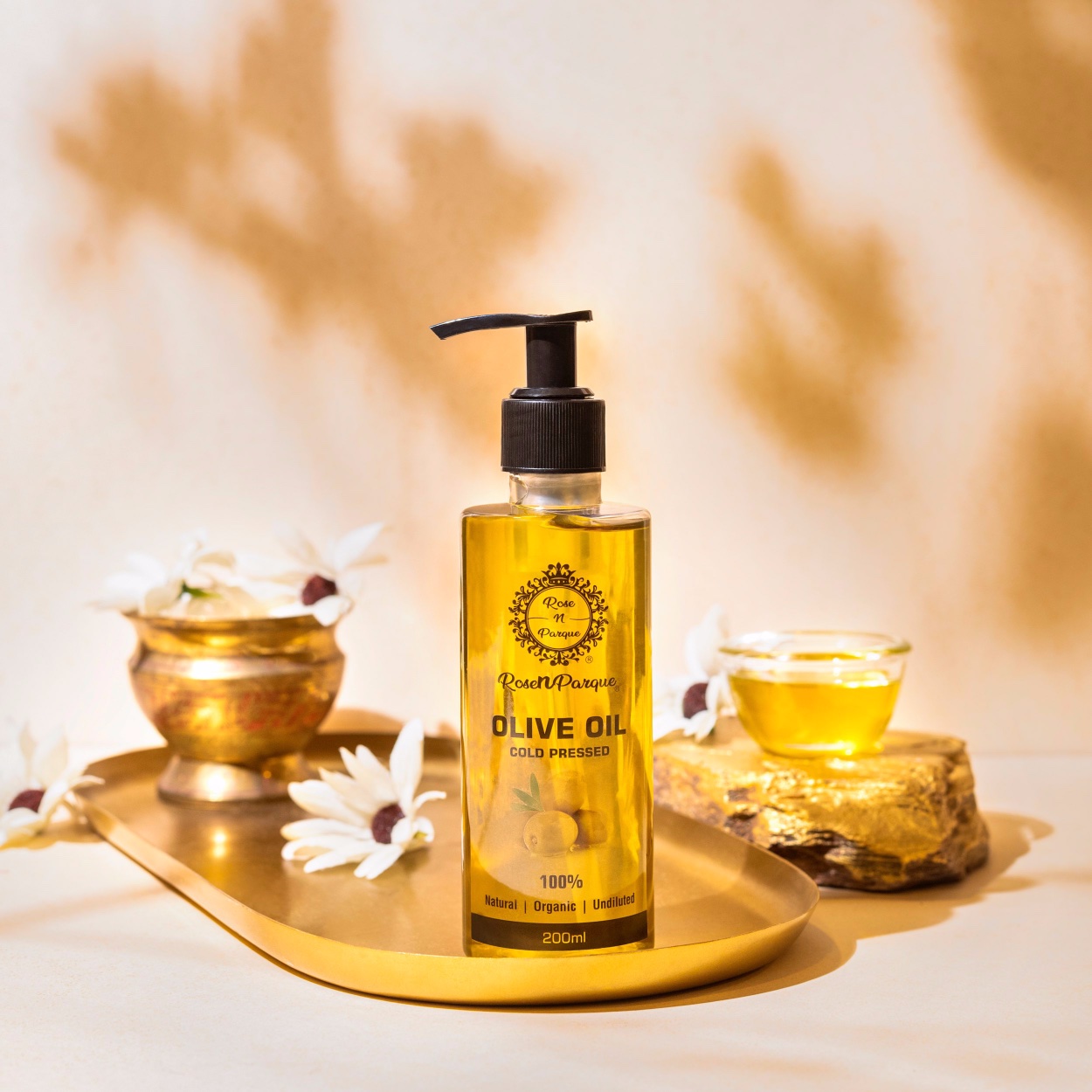 200ml bottle of cold pressed olive oil with a pump dispenser on a decorative tray.