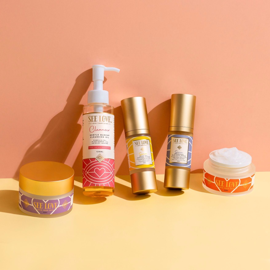 Five skincare products from the Self Love brand displayed on a colorful background.