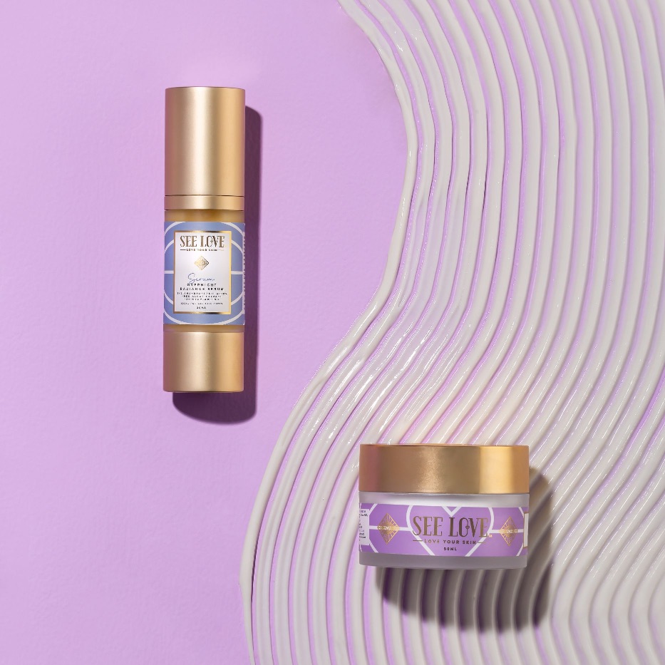 Two SEE LOVE skincare products on a purple background with textured waves.
