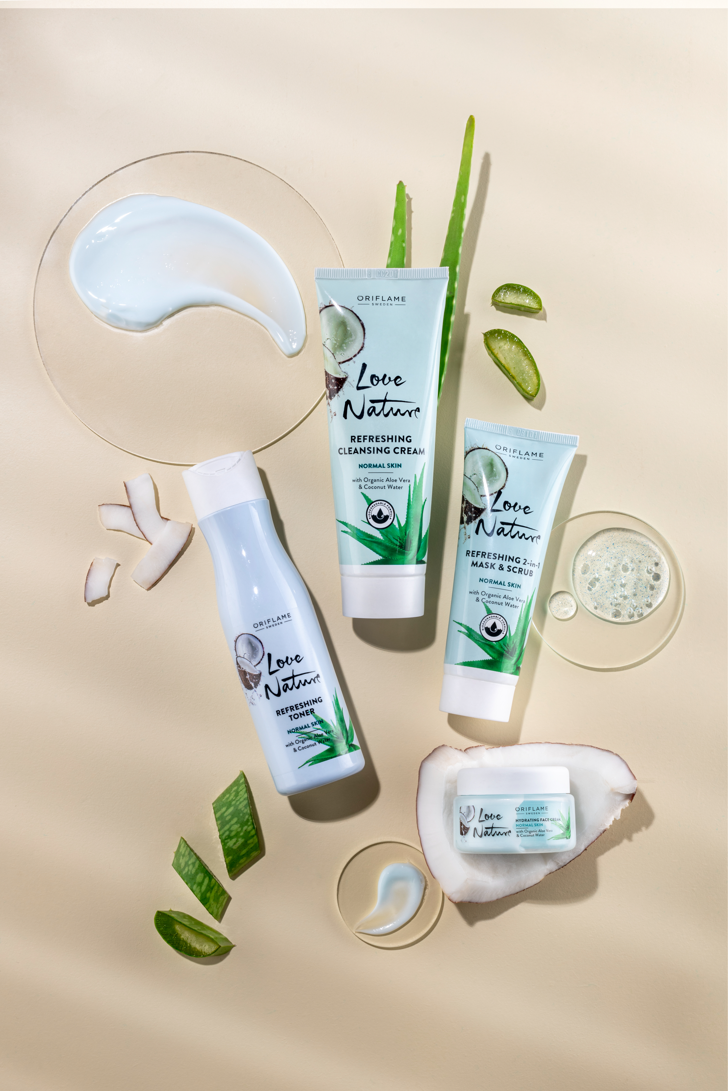 Three Love Nature skincare products including cleansing cream, shampoo, and a small cream tube on a neutral background.