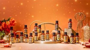 Various bottles of essential oils arranged on a display with a warm background.