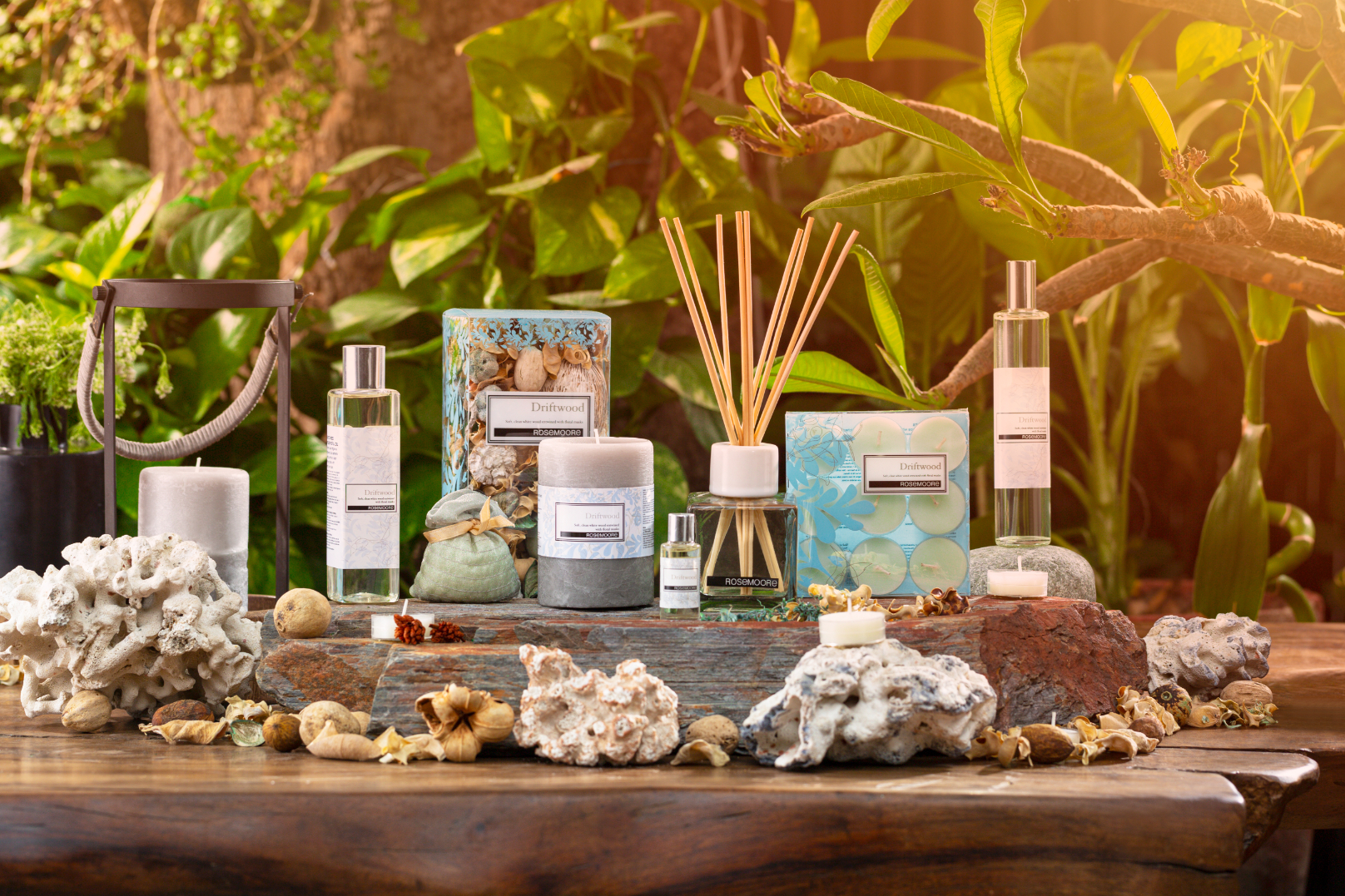 A collection of various scented candles and diffusers arranged on a wooden surface.